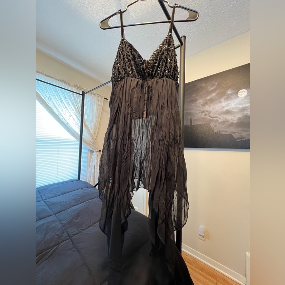 Flowy top with sequin and beaded detail.